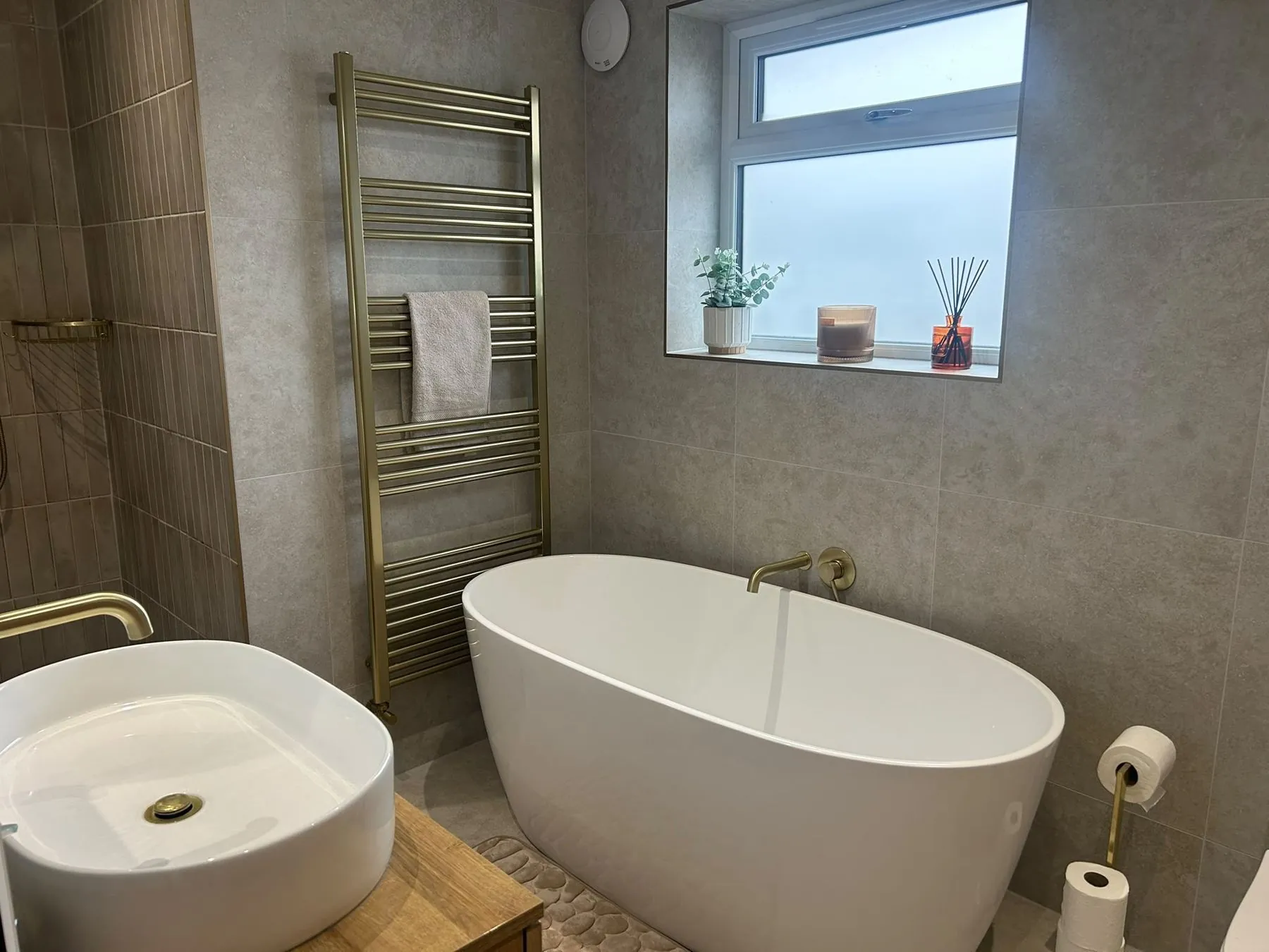 Bathroom with freestanding bath and brass fittings