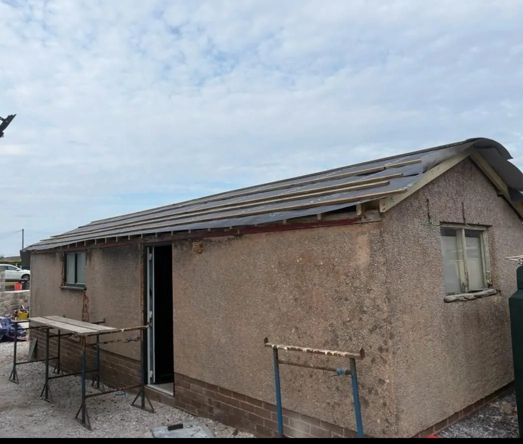 The outbuilding with its roof stripped