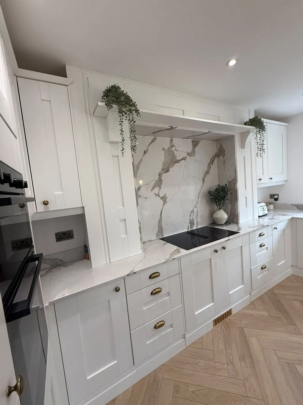 Kitchen run with marble splashback