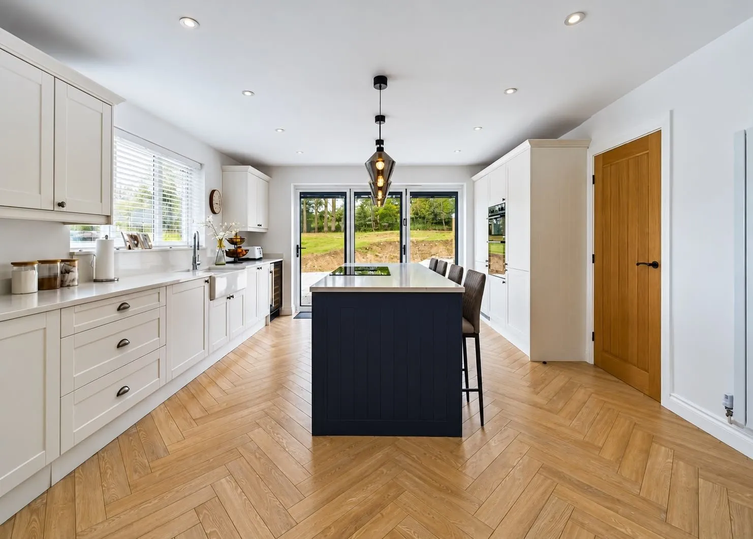 The new kitchen with island and doors to the garden